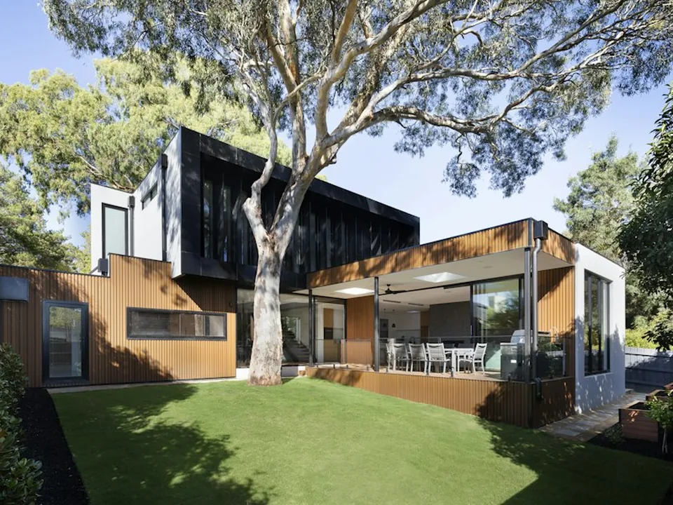 Black-framed sliding glass door opening to a garden